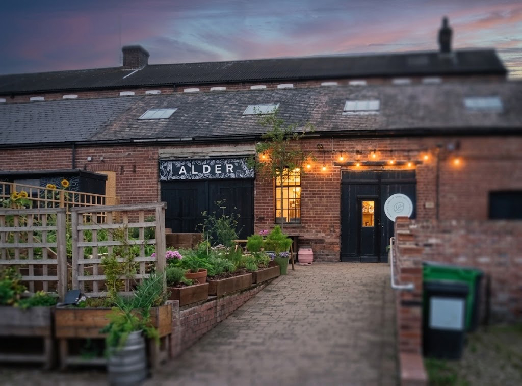 Live music performance and outdoor courtyard crowd at Alder during Kelham Pride festival