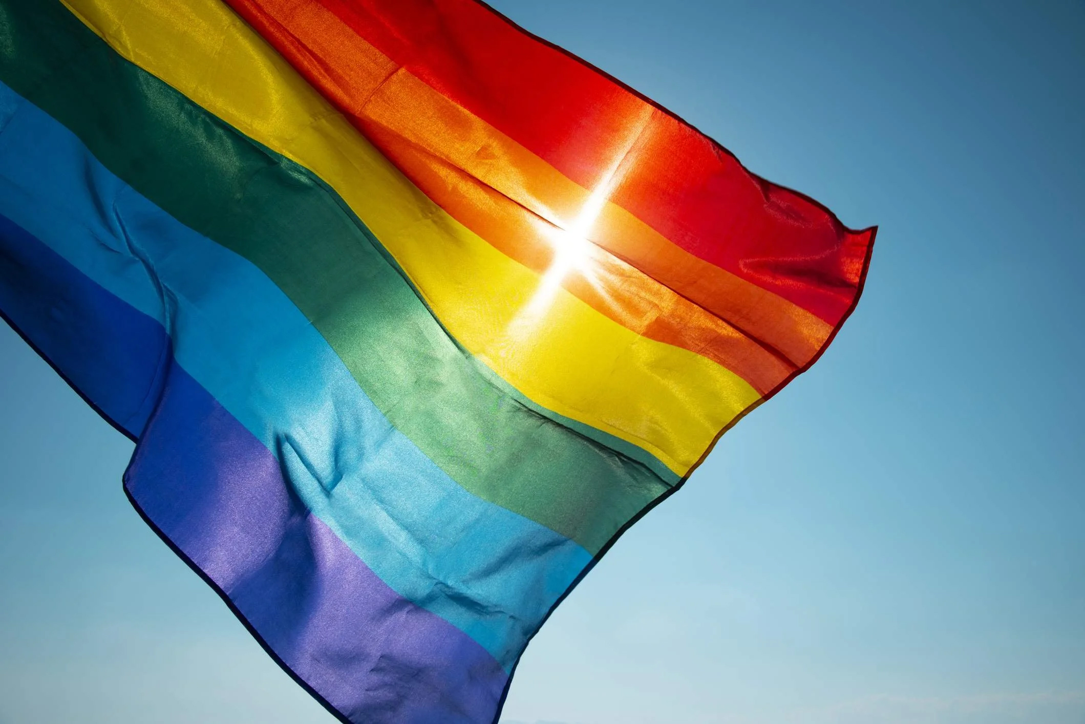 Large Pride Flag flown in clear skies in Kelham Island, Sheffield.